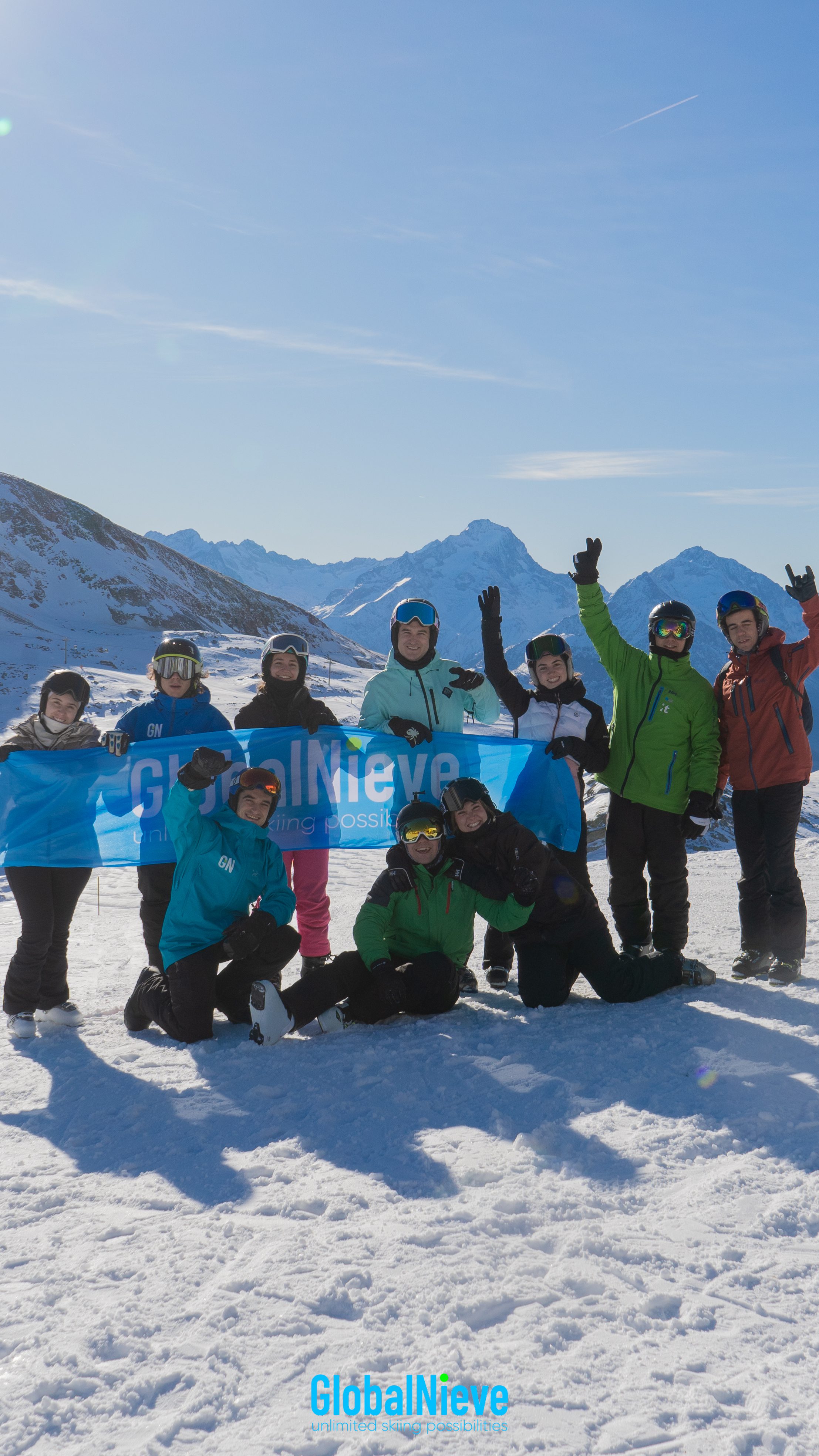 Group of young skiers holding a Globalnieve banner